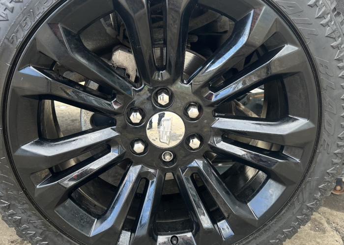 Black truck featuring sleek black rims, emphasizing a bold and modern aesthetic.