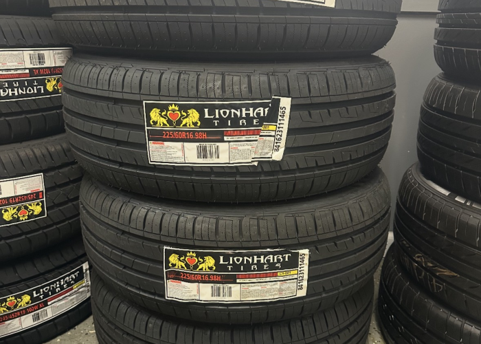 Several tires stacked vertically in a warehouse, showcasing a neat arrangement for storage and organization.